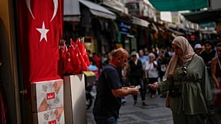 A seller talks to a customer in a street market in Istanbul, Turkey, on Sept. 6, 2023. 