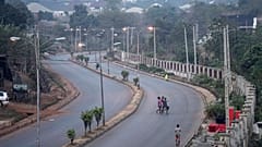 People walk across a normally packed highway during a separatists imposed lockdown in Enugu, Nigeria, 14 February 2022.
