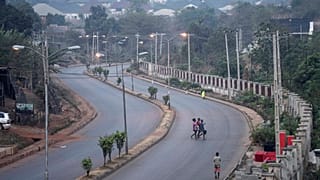 People walk across a normally packed highway during a separatists imposed lockdown in Enugu, Nigeria, 14 February 2022.