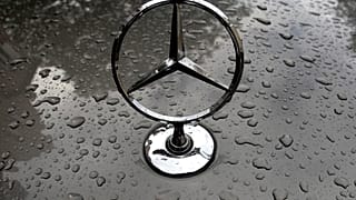 The logo of German car manufacturer Mercedes-Benz is rain covered at a car in Munich, Germany, Friday, July 28, 2017. 