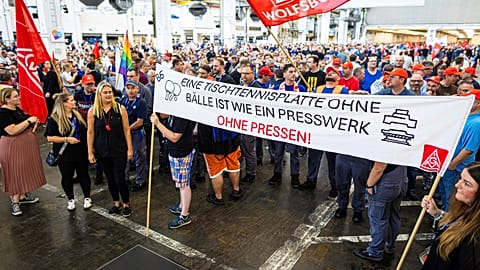 FILE photo- Employees protest before the start of a works meeting in a hall at the VW plant in Wolfsburg, Germany, Wednesday, Sept. 4, 2024. 