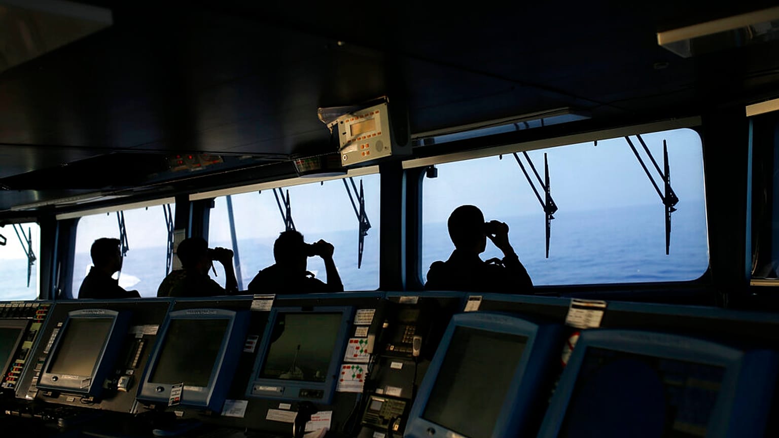 FILE PHOTO taken on Wednesday, Aug. 26, 2015, Portuguese navy ship NPR Viana do Castelo's crew members use binoculars on the bridge during a European Frontex migrant search