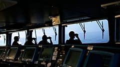 FILE PHOTO taken on Wednesday, Aug. 26, 2015, Portuguese navy ship NPR Viana do Castelo's crew members use binoculars on the bridge during a European Frontex migrant search