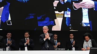 Mukhtar Babayev, COP29 President, center, applauds during a closing plenary session at the COP29.