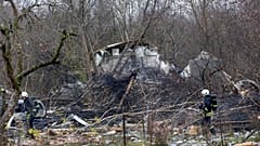 Lithuanian ministry employees, emergency workers and police stand near the spot where the DHL cargo plane crashed Vilnius, Lithuania, 25.11.2024
