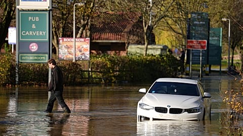 A stranded car in flood water at the Billing Aquadrome as Storm Bert continues to cause disruption in Northampton, England, Monday, Nov. 25, 2024. Jordan Pettitt/PA via AP)