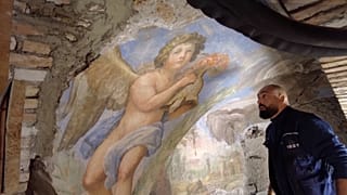 Electrician Davide Renzoni looking at the cherub fresco he discovered 