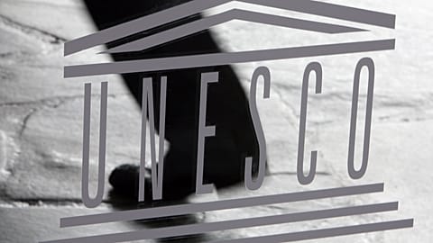 The United Nations Educational, Scientific and Cultural Organisation (UNESCO) logo is seen on a glass door at the UNESCO headquarters in Paris, Saturday Sept. 19, 2009. 