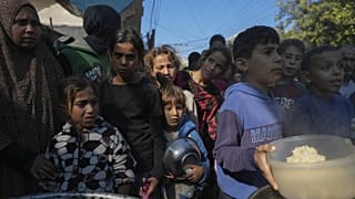 Palesztin gyerekek sorban állnak a gázai Deir al-Balah egyik ételosztó konyhájánál
