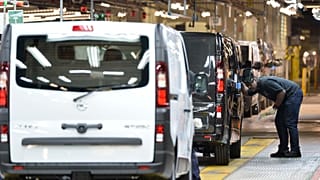 An employee inspects a car at the Vauxhall vehicle production plant in Luton, England. 2 February 2015.