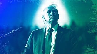 Republican presidential nominee and former President Donald Trump watches a video screen at a campaign rally in Salem, VA, November 2024