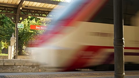 A commuter train circulates through a train station in Andalusia, Spain