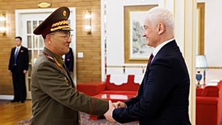 North Korean Defense Minister No Kwang Chol, left, and Russian Defense Minister Andrei Belousov, right, shake hands during their meeting in Pyongyang, North Korea, Friday.