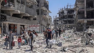 Palestinians walk through the destruction in the wake of an Israeli air and ground offensive in Jebaliya, northern Gaza Strip.