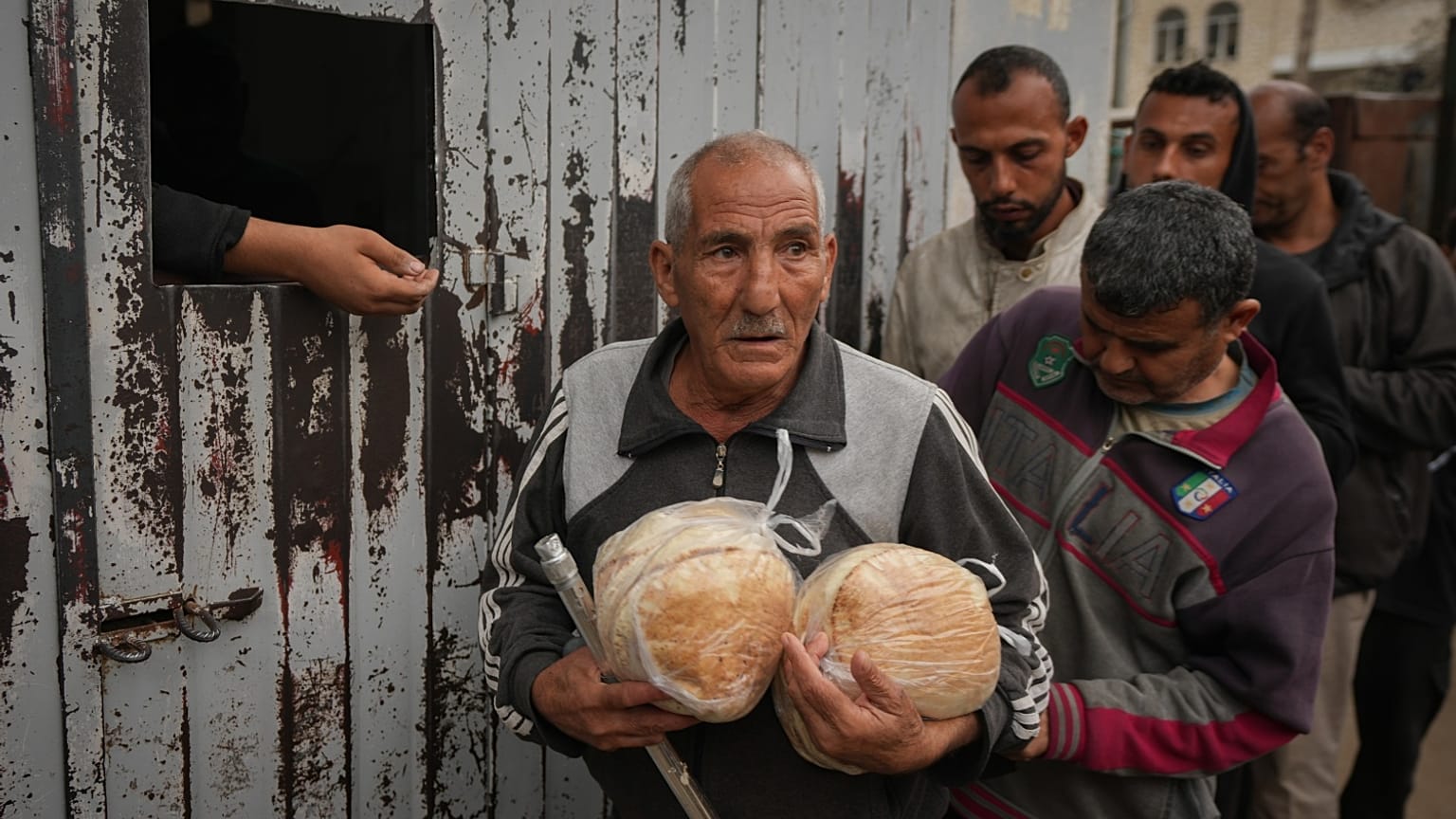 فلسطيني يحمل الخبز بعد الحصول عليه من أحد المخابز في دير البلح، قطاع غزة، الجمعة 29 نوفمبر 2024.