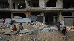 أطفال فلسطينيون يسرقون لحظات لهو على أنفاض بناية مدمرة في خان يونس جنوب غزة. 01/12/2024