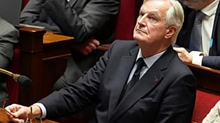 French Prime Minister Michel Barnier attends a debate at the National Assembly as France's minority government totters on the brink