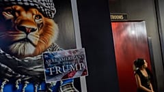 A sign is displayed during an Arab Americans for Trump election watch party at Lava Java Cafe, a hookah lounge, in the early hours of 6 November 2024, in Dearborn, Michigan