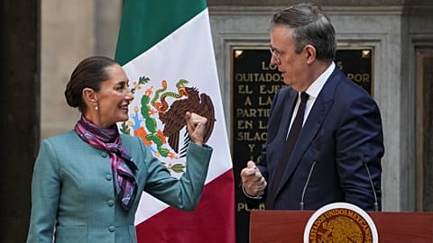 Mexican President Claudia Sheinbaum, left, speaks with her Economy Secretary Marcelo Ebrard during a news conference at the National Palace in Mexico City.