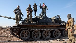 Rebel fighters on the outskirts of Hama, Syria, on 3 December, 2024. 