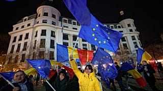 People wave Romanian and European Union flags during a pro-European rally ahead of the country's Dec. 8 runoff presidential elections.