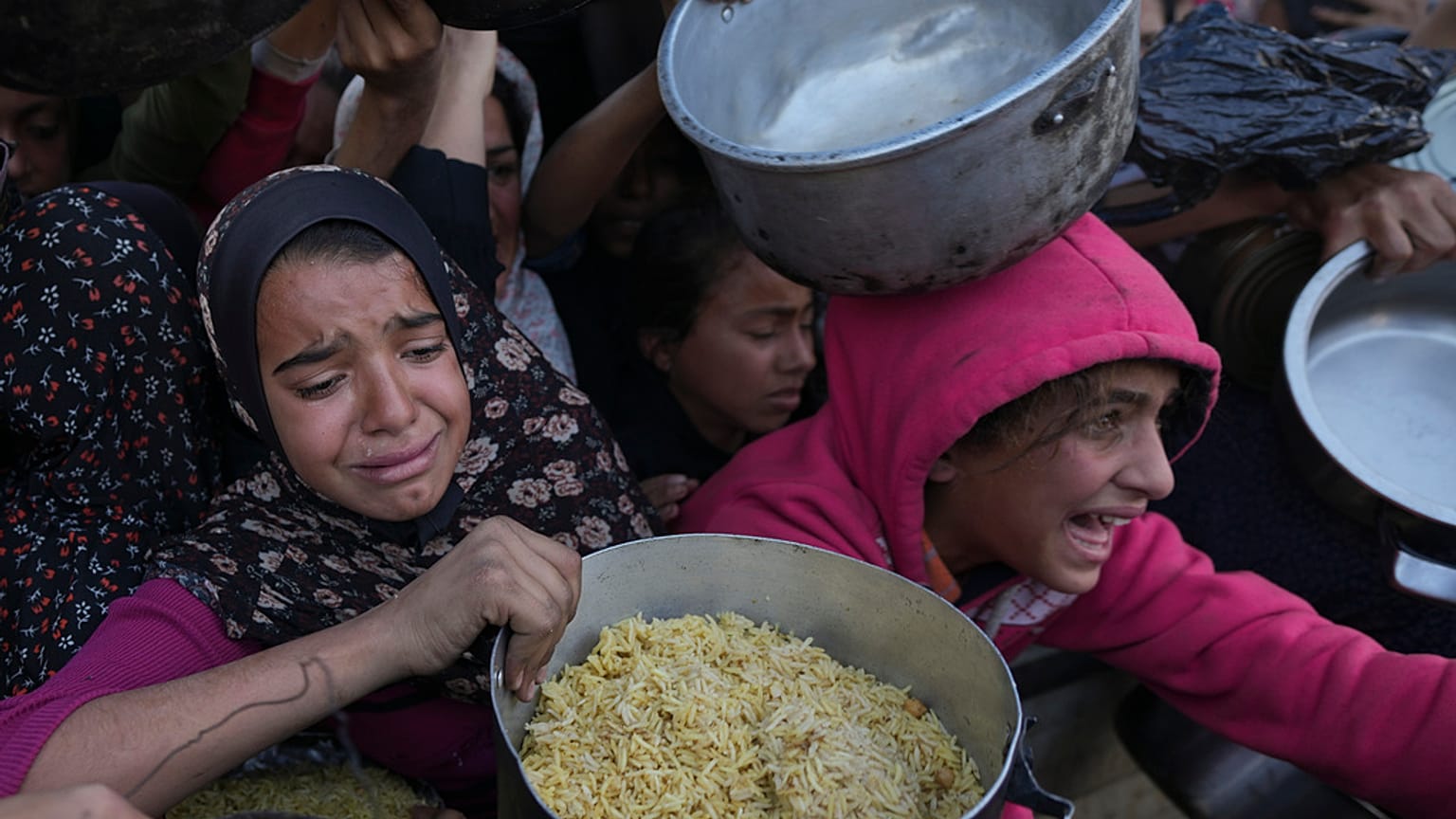 فتيات فلسطينيات يكافحن للوصول إلى الطعام في مركز توزيع في خان يونس بقطاع غزة يوم الجمعة، 6 ديسمبر/كانون الأول 2024.