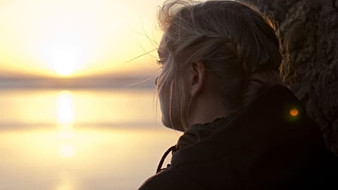 A young woman looks out over the horizon.
