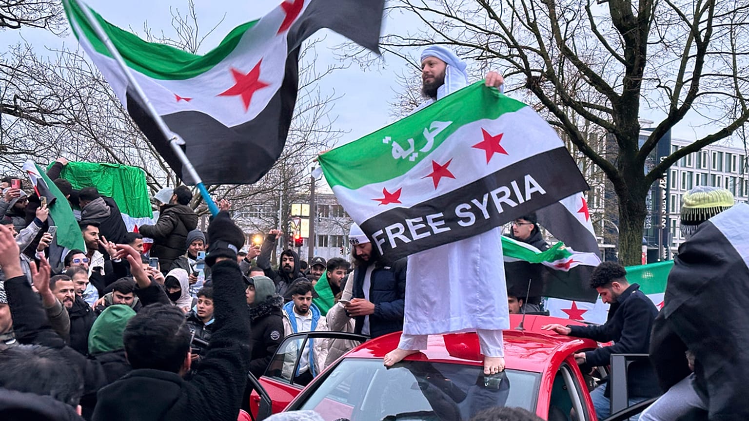People celebrate the fall of the Assad regime, in Rostock, Germany, Sunday, Dec. 8, 2024.