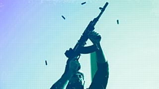 An opposition fighter fires his AK-47 in the air in celebration after opposition forces took control of the city in Damascus, 8 December 2024
