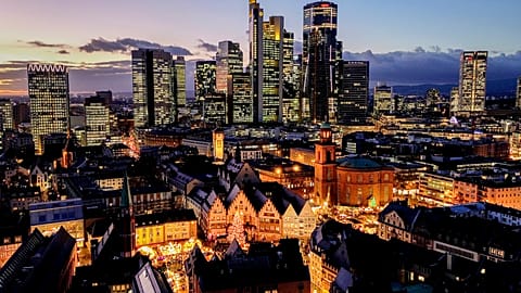 A Christmas market in Roemerberg square with the main business district in Frankfurt, Germany