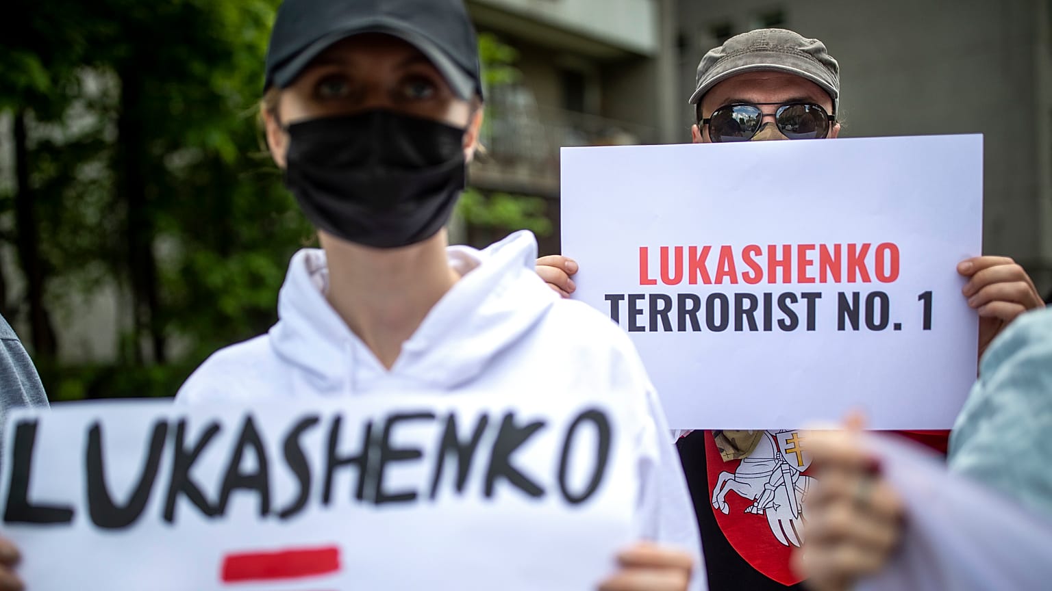 Protesters hold banners during a demonstration demanding freedom for Belarus opposition activist Raman Protasevich in Vilnius, 28 May, 2021 
