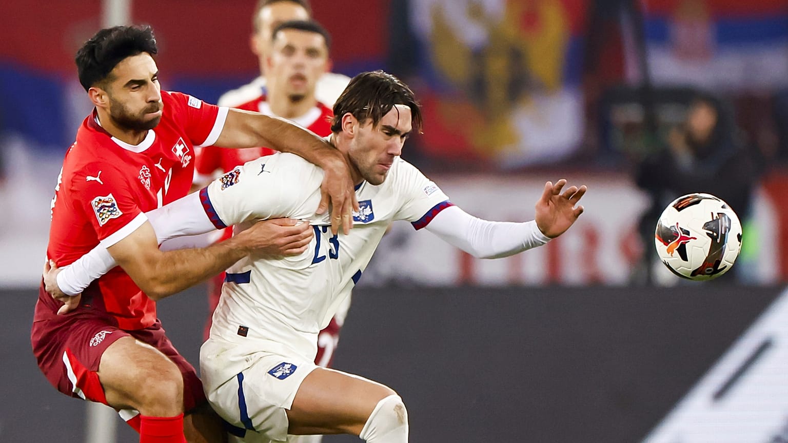 Switzerland's Eray Comert, left, and Serbia's Dusan Vlahovic in action during the UEFA Nations League soccer match between Switzerland and Serbia in Zurich.