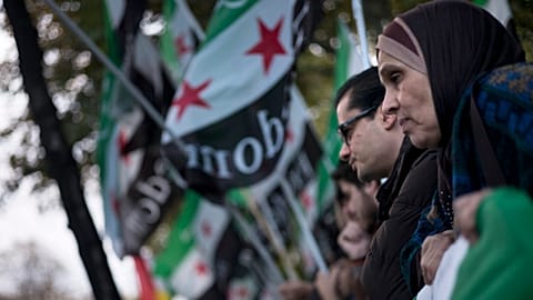 Protesters gather across the street from the Hotel Imperial in Vienna where Syria peace talks took place, 30 October, 2015