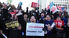 Participants react after hearing the news that South Korea's parliament voted to impeach President Yoon Suk Yeol outside the National Assembly in Seoul