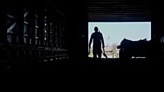 Contract worker from Mexico, carries tools back while doing maintenance inside a tobacco barn 