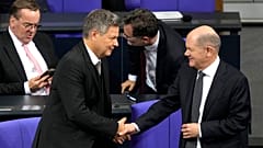German Chancellor Olaf Scholz, right, shakes hand with Economy and Climate Minister Robert Habeck after losing a vote of confidence in parliament 