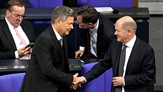 German Chancellor Olaf Scholz, right, shakes hand with Economy and Climate Minister Robert Habeck after losing a vote of confidence in parliament