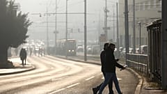Des personnes traversent la rue dans un brouillard de pollution, alors que le smog recouvre Sarajevo, en Bosnie, en décembre 2024.