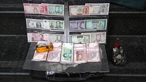 File picture of current and pre-revolution Iranian banknotes and foreign currencies are displayed by a vendor in the commercial district of Tehran