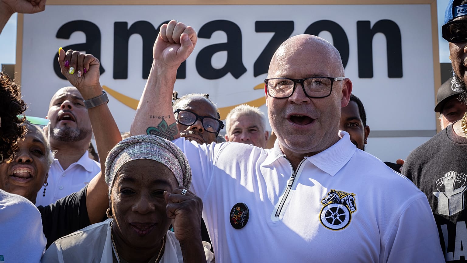 FILE - Teamsters General President Sean M. O'Brien, center, rallies with Amazon workers outside the Staten Island Amazon facility JFK8, June 19, 2024, in New York.