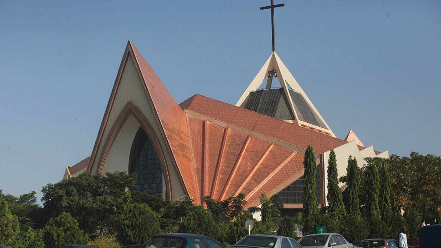 FILE - Nov. 11, 2011, a man stands in front an Inter-denominational church in modern architectural design in Abuja, Nigeria.