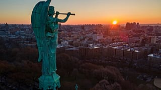 FILE - The Archangel Gabriel blowing a trumpet stands at the Cathedral of St. John the Divine, March 2023