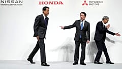 Nissan Chief Executive Makoto Uchida, left, Takao Kato, CEO of Mitsubishi Motors, centre, and Honda Chief Executive Toshihiro Mibe, leave after a news conference in Tokyo