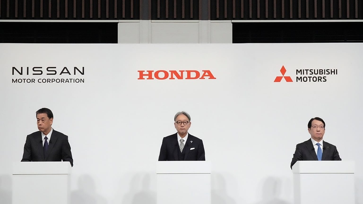 Nissan Chief Executive Makoto Uchida, left, Honda Chief Executive Toshihiro Mibe, center, and Takao Kato, CEO of Mitsubishi Motors, right, attend a joint news conference in To