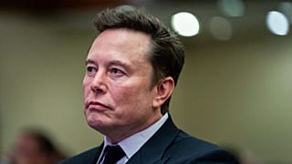 Elon Musk listens as President-elect Donald Trump speaks during a meeting with the House GOP conference, Wednesday, Nov. 13, 2024, in Washington.