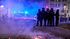 Police officers stand guard in the streets after fireworks for the New Year's celebrations in Berlin, Germany, Wednesday, Jan. 1, 2025. 