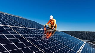 Un técnico instalando paneles solares.
