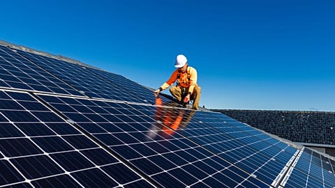 A technician installing solar panels.