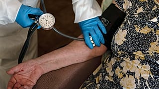 FILE - A doctor checks the blood pressure of A 94-year-old woman in Sant Sadurní d'Anoia, Catalonia region, Spain, Friday, July 31, 2020.