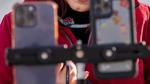 Wearing a button in support of TikTok, Tiffany Cianci, who says she is a "long-form educational content creator," livestreams to TikTok outside the Supreme Court, Friday, Jan.